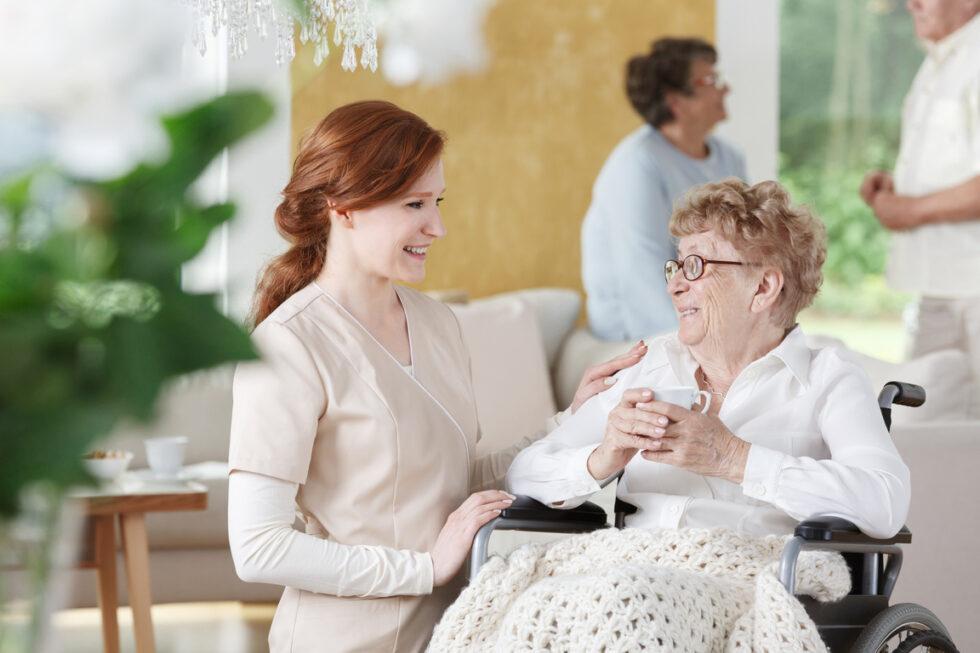 Caregiver providing personalized assistance to an elderly resident at Aliviya Rose Manor
