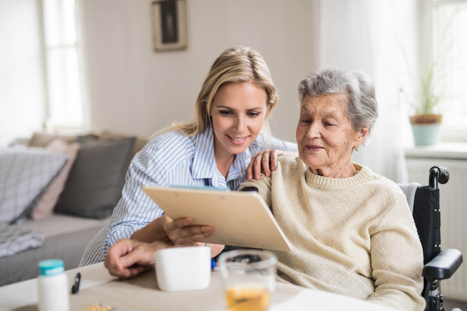 Two elderly women sitting and talking